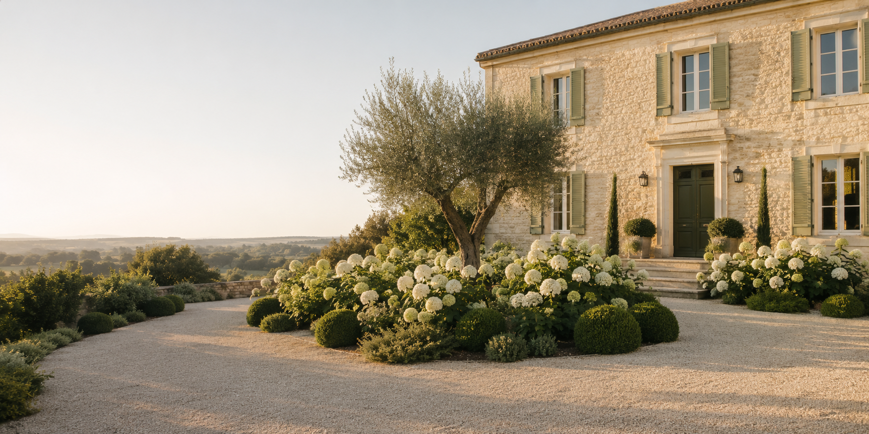 Elegant European garden with limestone architecture, white hydrangeas and clipped evergreens